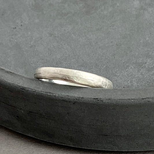 Silver ring on a dark gray surface