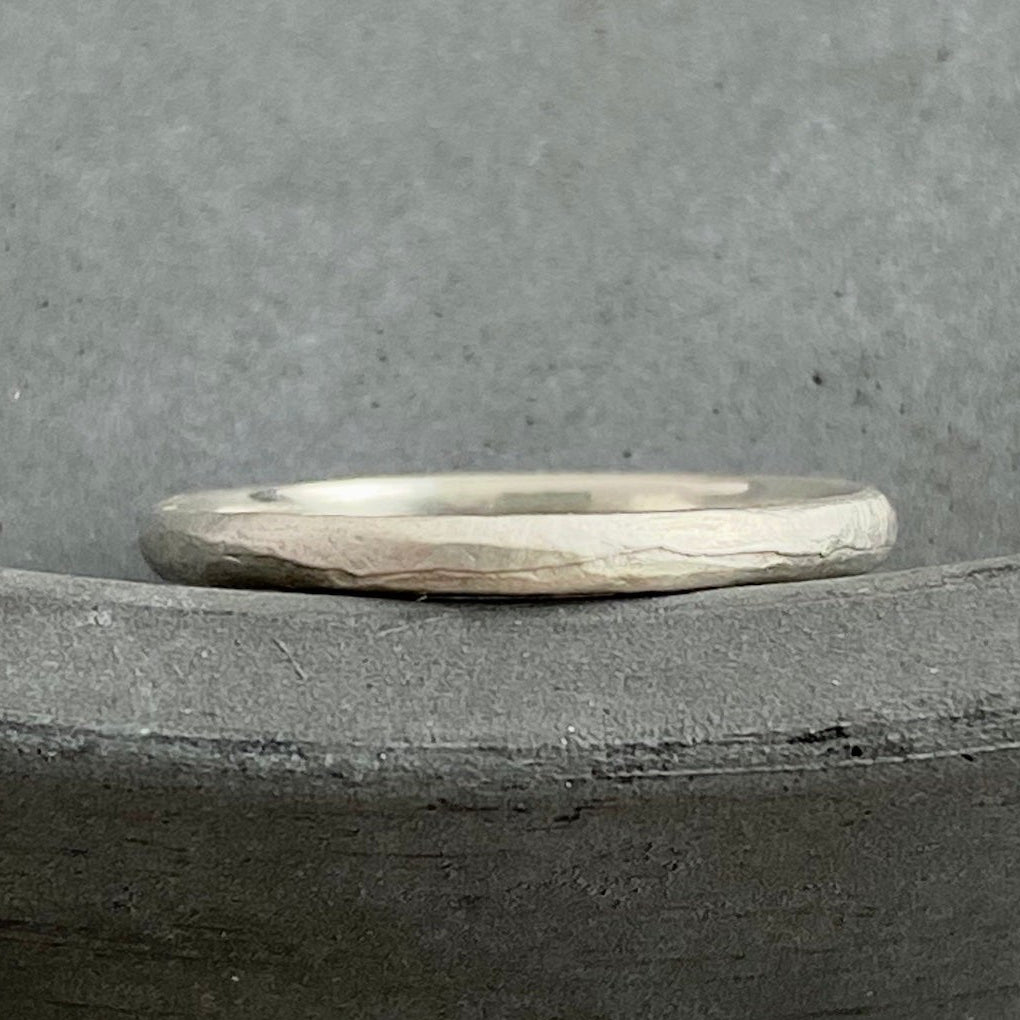 Silver ring on a gray concrete surface