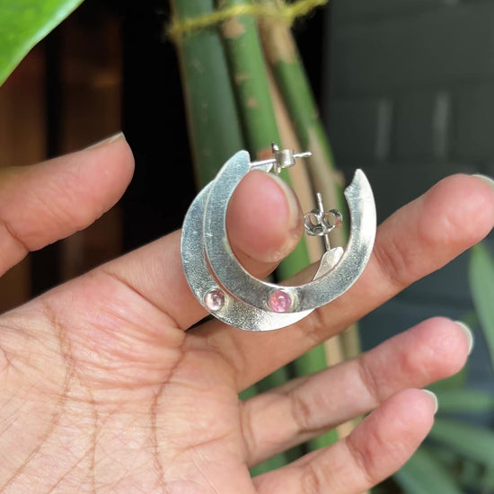video of large silver hoops with pink tourmalines
