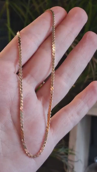video of a delicate 9ct yellow gold chain in a hand