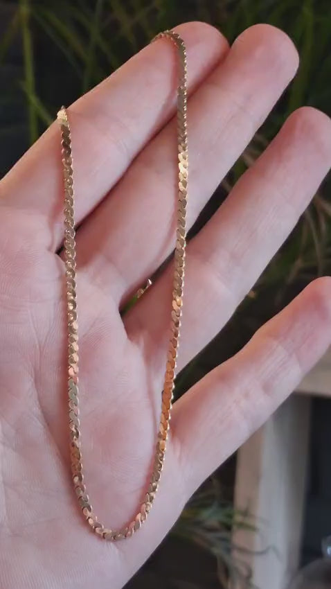 video of a delicate 9ct yellow gold chain in a hand